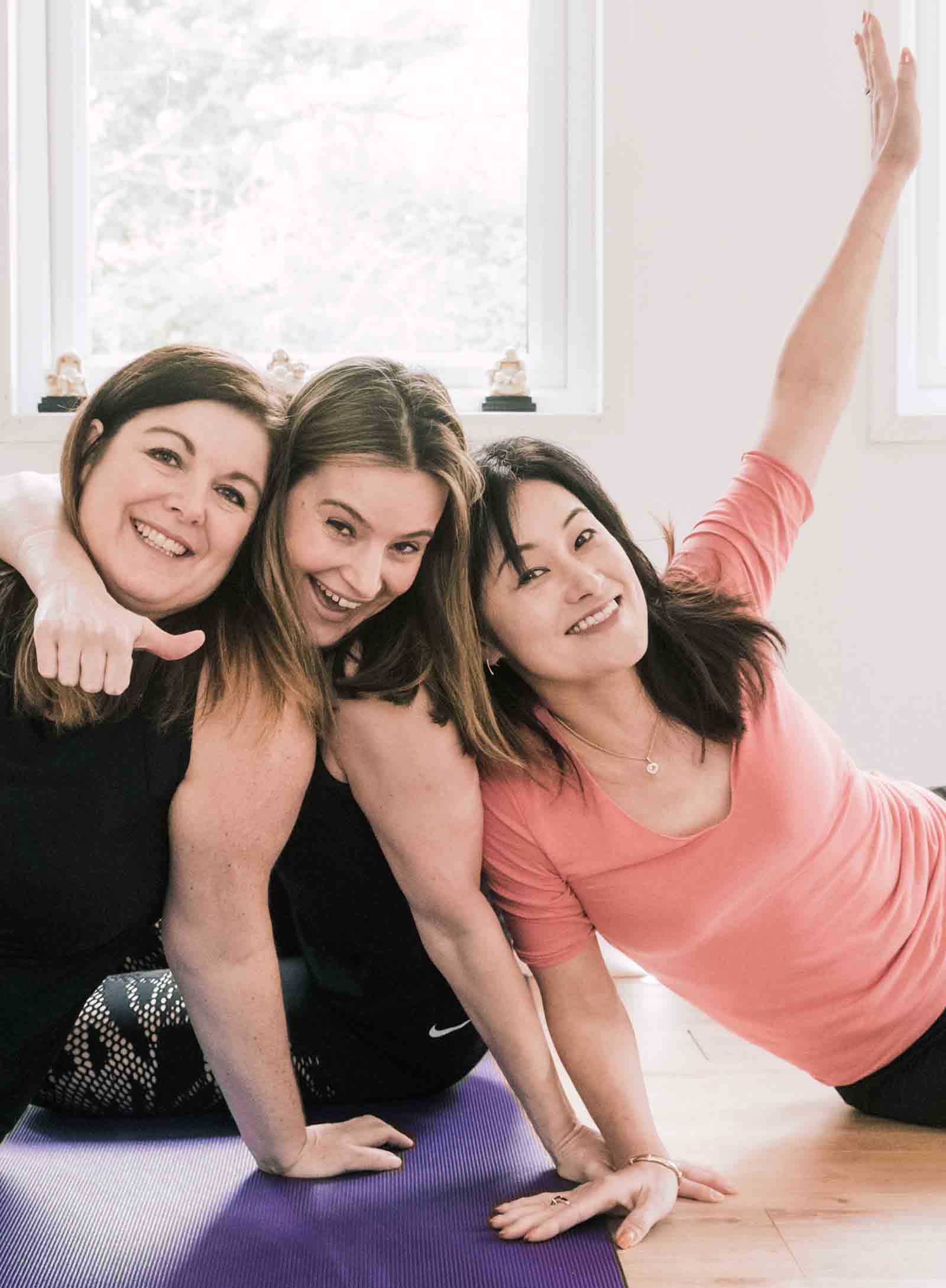 Group of three friends enjoying a yoga lesson by Jacqui Doyle in her studio